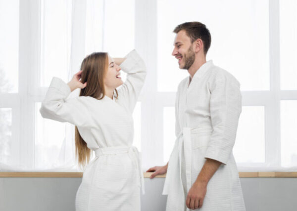 Side View Couple Bathrobes Looking Each Other